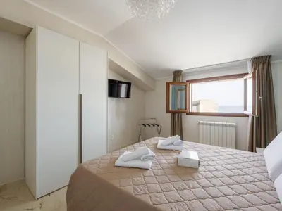a bedroom with a bed with two towels on it at Apartment Pirandello by Interhome in Balestrate