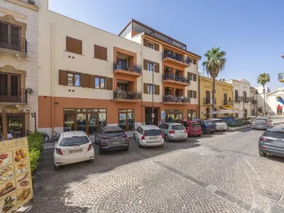 a street with cars parked in front of a building at Apartment A Lapa by Interhome in Balestrate