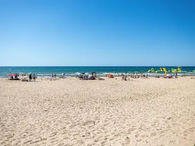 a group of people on a beach near the ocean at Apartment A Lapa by Interhome in Balestrate