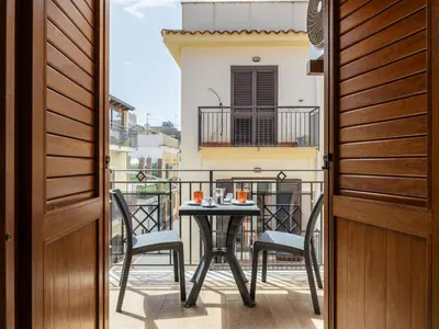 a balcony with a table and chairs on a balcony at Apartment A Lapa by Interhome in Balestrate