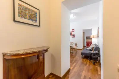 a living room with a table and a couch at Piazza Marina Holiday House by DomuSicily in Palermo