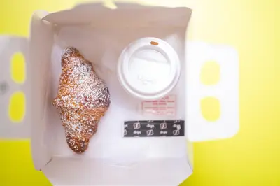 a piece of food in a box with a scale at Splendori Rooms in Palermo