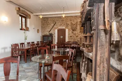 a restaurant with tables and chairs and a brick wall at Agriturismo Case Tabarani in Collesano