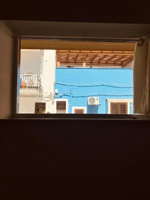 a view from a window of a blue building at Casa Praiola in Terrasini
