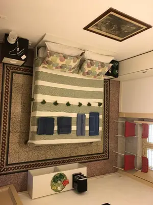 a room with a bed with a table in it at B&B Giulio Cesare 24 in Palermo