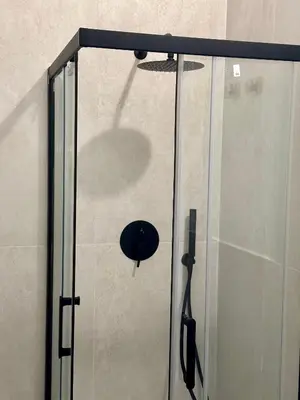 a glass shower door with a shower head at La Dimora Del Centro in Palermo