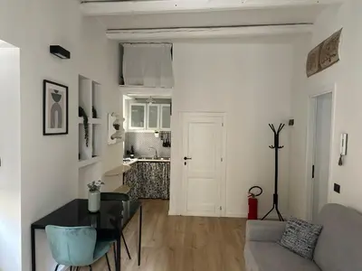 a living room with a table and a couch at La Dimora Del Centro in Palermo