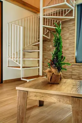 a small christmas tree sitting on a wooden table at Sunflower Apartment in Palermo