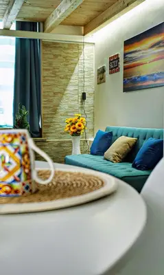 a living room with a couch and a chair at Sunflower Apartment in Palermo