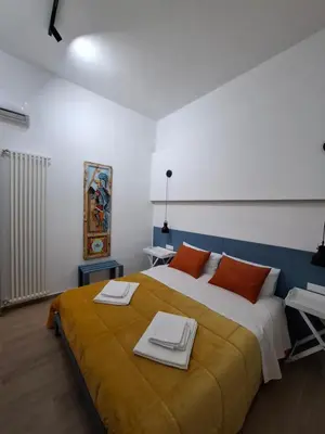 a bedroom with a large bed with towels on it at Donna Rosa House in Palermo