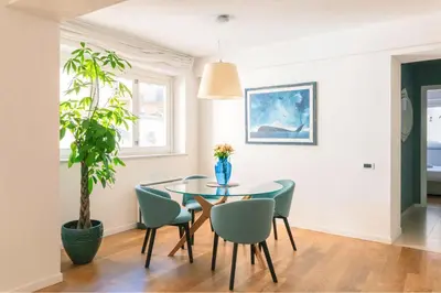 a dining room with a glass table and chairs at Le Sicilien - Moncada de Luna Exclusive Stay in Palermo