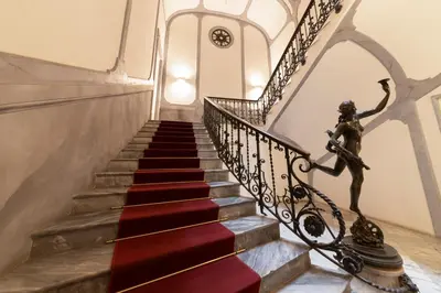 a stairway with a statue of a woman on it at Le Sicilien - Moncada de Luna Exclusive Stay in Palermo