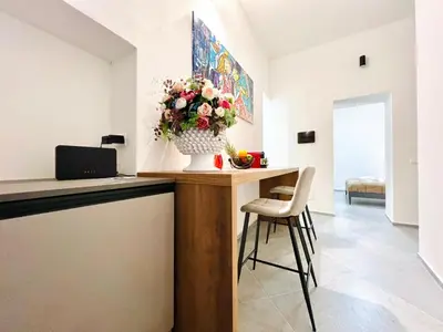 a room with a table with a vase of flowers on it at Pretoria Suites in Palermo
