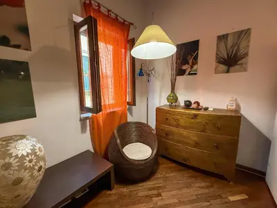 a room with a wooden dresser and a ottoman at Loft in Kalsa - By Rental BeB - in Palermo