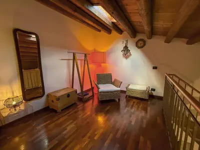 a living room with a chair and a table at Loft in Kalsa - By Rental BeB - in Palermo