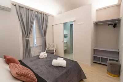 a bedroom with a bed with two towels on it at Scic House in Palermo