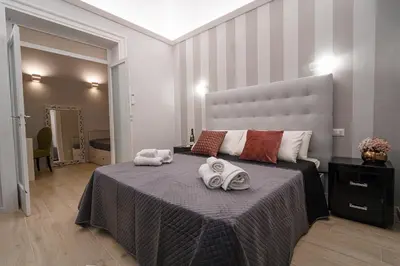 a bedroom with a large bed with towels on it at Scic House in Palermo