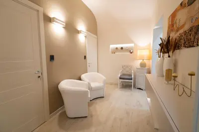 a bathroom with a toilet and a chair in a room at Scic House in Palermo
