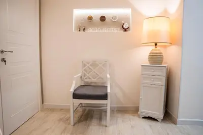 a room with a chair and a table with a lamp at Scic House in Palermo