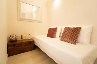 a bedroom with a bed with white sheets and pillows at Scic House in Palermo