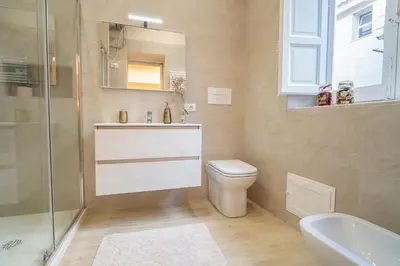 a bathroom with a toilet and a sink and a shower at Scic House in Palermo