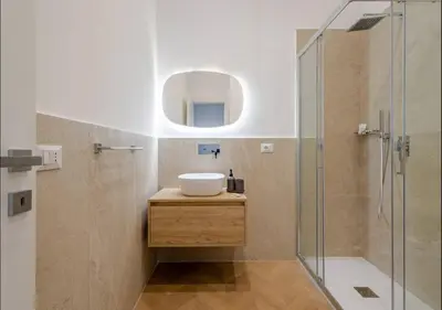 a bathroom with a sink and a glass shower at Residenza Camillo - Palermo Centro in Palermo