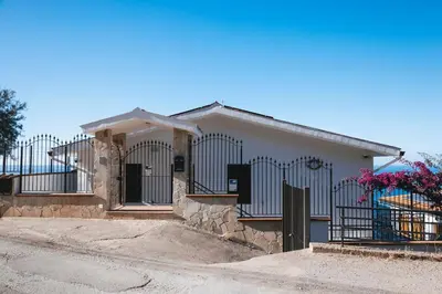 a house with a gate in front of it at Trabia Villa Bedda Mia A in Trabia