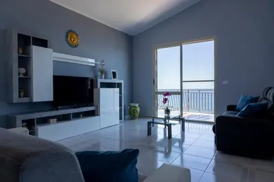 a blue living room with a couch and a television at Trabia Villa Bedda Mia A in Trabia