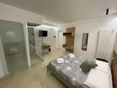 a bedroom with a bed and a glass shower at #Secretplace in Palermo