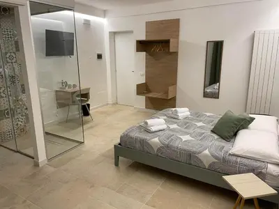 a bedroom with a bed and a glass shower at #Secretplace in Palermo