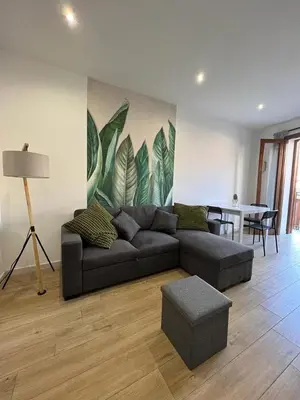 a living room with a couch and a table at Two-room apartment in the heart of Palermo in Palermo