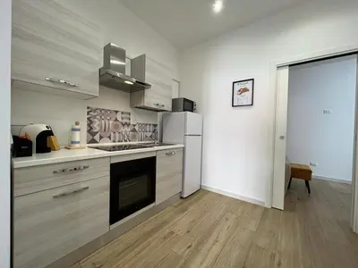 a kitchen with a refrigerator and a stove top oven at Two-room apartment in the heart of Palermo in Palermo