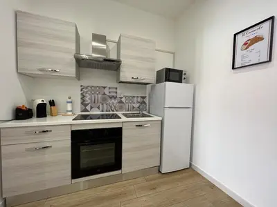a kitchen with a refrigerator and a stove at Two-room apartment in the heart of Palermo in Palermo