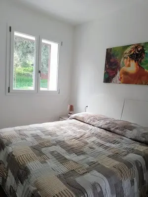 a bedroom with a bed and a painting on the wall at Holiday home 8 guests Granatelli in Altavilla Milicia