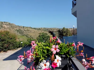 a bunch of flowers sitting on a balcony at Holiday home 8 guests Granatelli in Altavilla Milicia