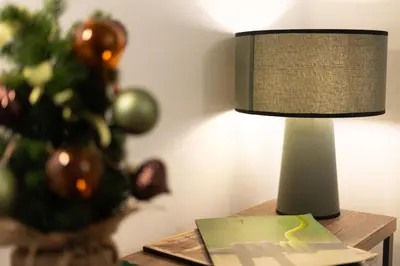 a lamp sitting on a table next to a christmas tree at Maison Castro Casetta a Palermo in Palermo