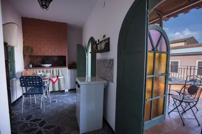 a room with a door and a table and chairs at Palazzo Viola Suite Panoramica Palermo in Palermo