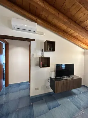 a living room with a flat screen tv on a wall at Massimo Boutique Apartment in Palermo