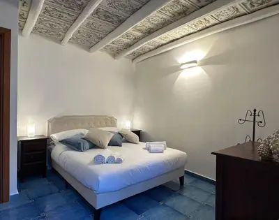 a bedroom with a large white bed in a room at Massimo Boutique Apartment in Palermo