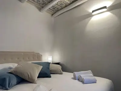 a bedroom with a bed with two towels on it at Massimo Boutique Apartment in Palermo