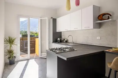 a kitchen with white cabinets and a stove at La casetta di Levante in Terrasini