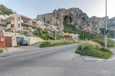an empty street in front of a mountain at Casa Azzurra vista mare all'Addaura by Wonderful Italy in Palermo