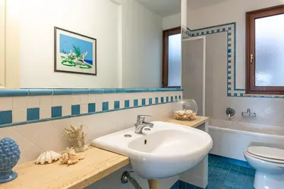 a bathroom with a sink and a toilet at Casa Azzurra vista mare all'Addaura by Wonderful Italy in Palermo