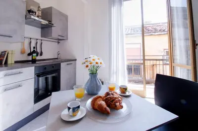 a table with a plate of pastries and two glasses of orange juice at I tre Mori in Monreale