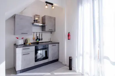 a kitchen with a sink and a stove at I tre Mori in Monreale