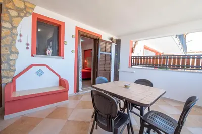 a dining room with a table and chairs at A Casa di Amy in Macari