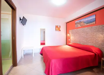 a bedroom with a red bed in a room at A Casa di Amy in Macari