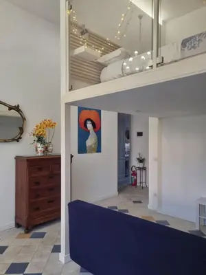 a room with a painting of a woman in a red hat at Casa Mondello Sea Life in Palermo