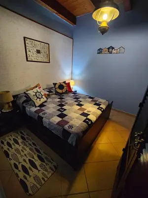 a bedroom with a bed with a checkered blanket at La Muciara - Best Hospitality in Palermo