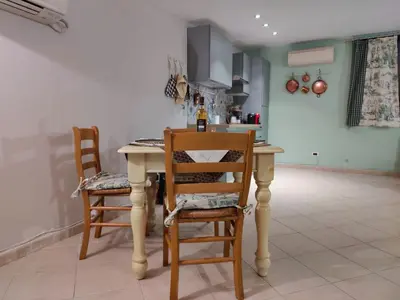 a kitchen with a table and two chairs at La Muciara - Best Hospitality in Palermo